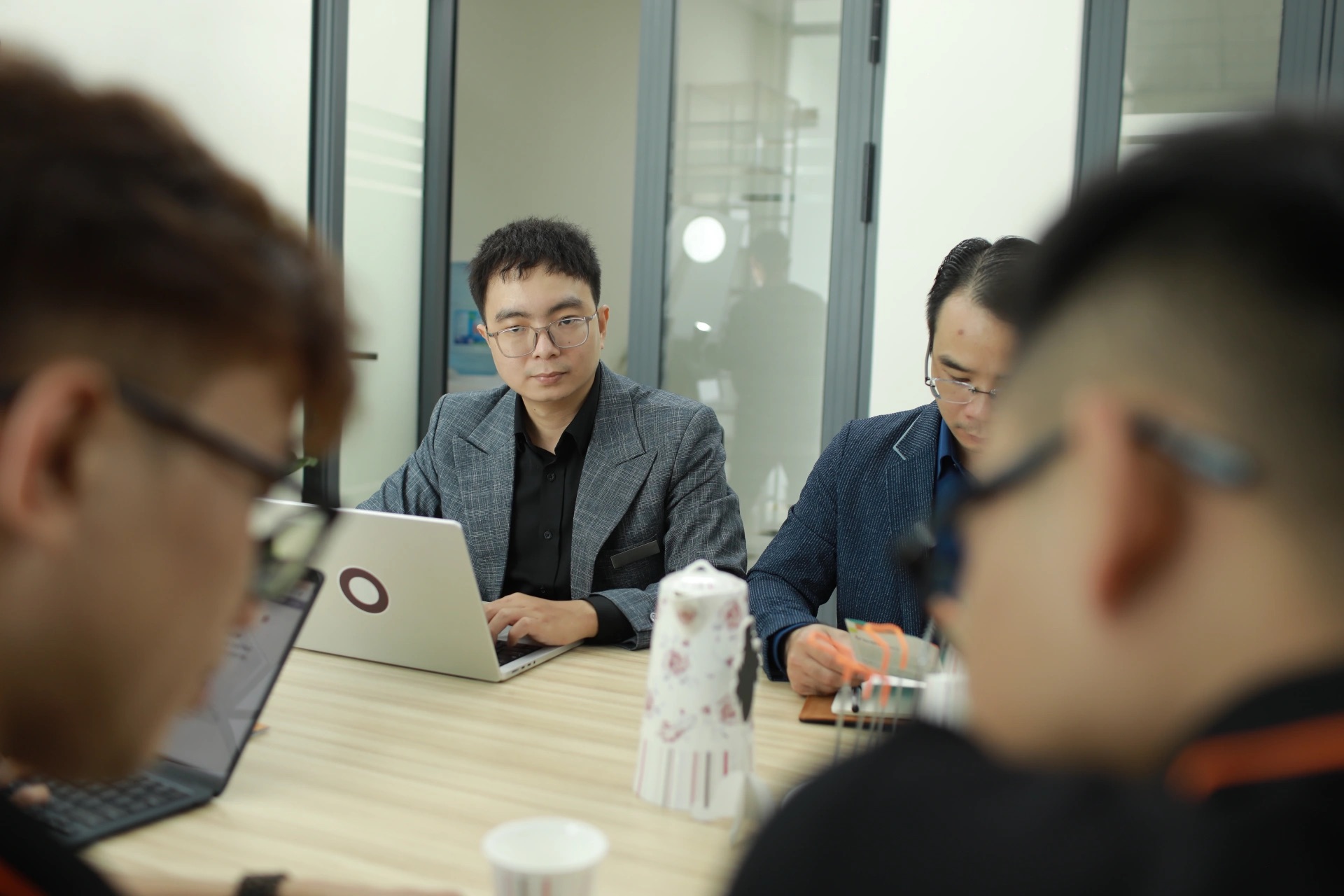 Trobz team members in a project meeting around a table with laptops